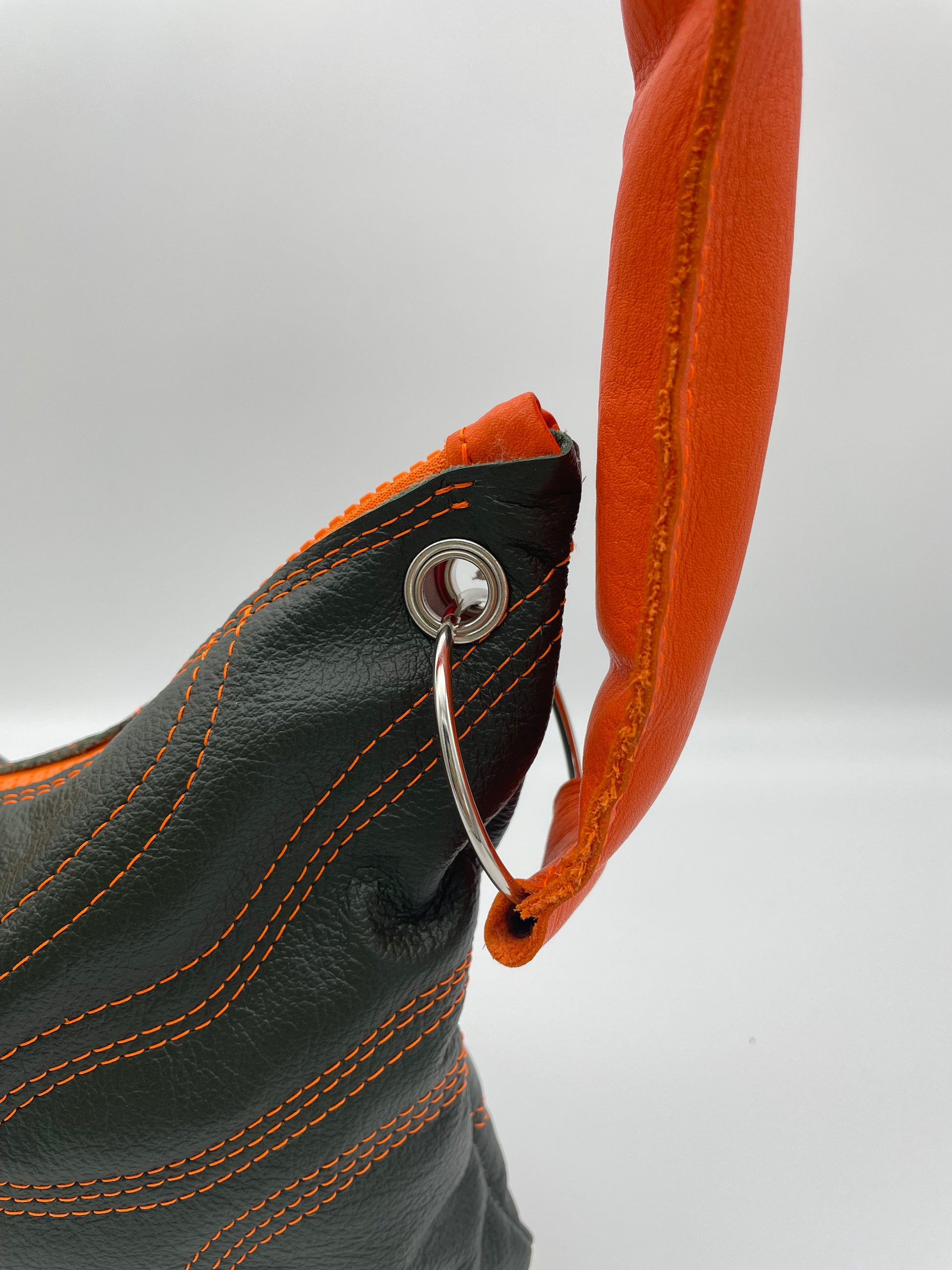 upcycling leather strap metal ring bag orange green waves padded strap
